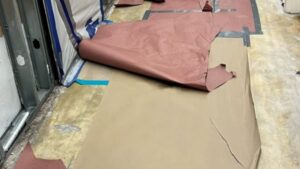 carboard protection ripped exposing concrete flooring