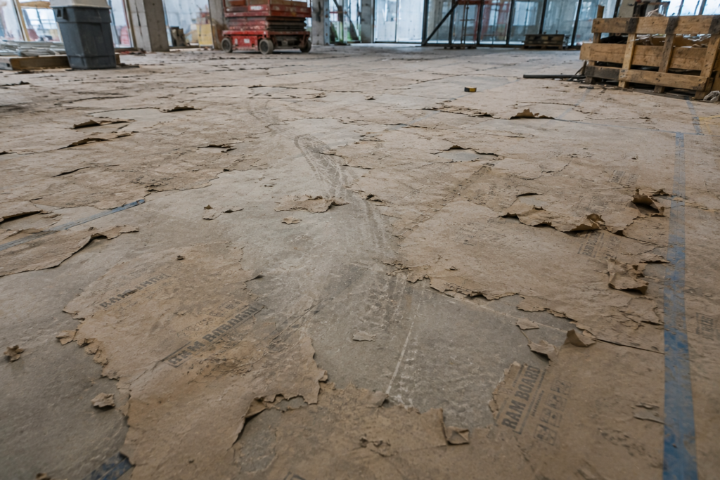 torn construction board on a concrete floor in construction site