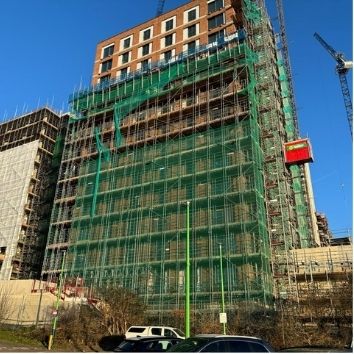 building during construction with scaffolding, the glass on this project had Protectapeel protective coating to protect from damage
