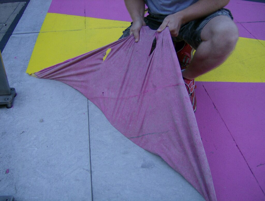 Peeling painted Protectapeel coating from concrete floor, removing a temporary art installation at channel 4 studios